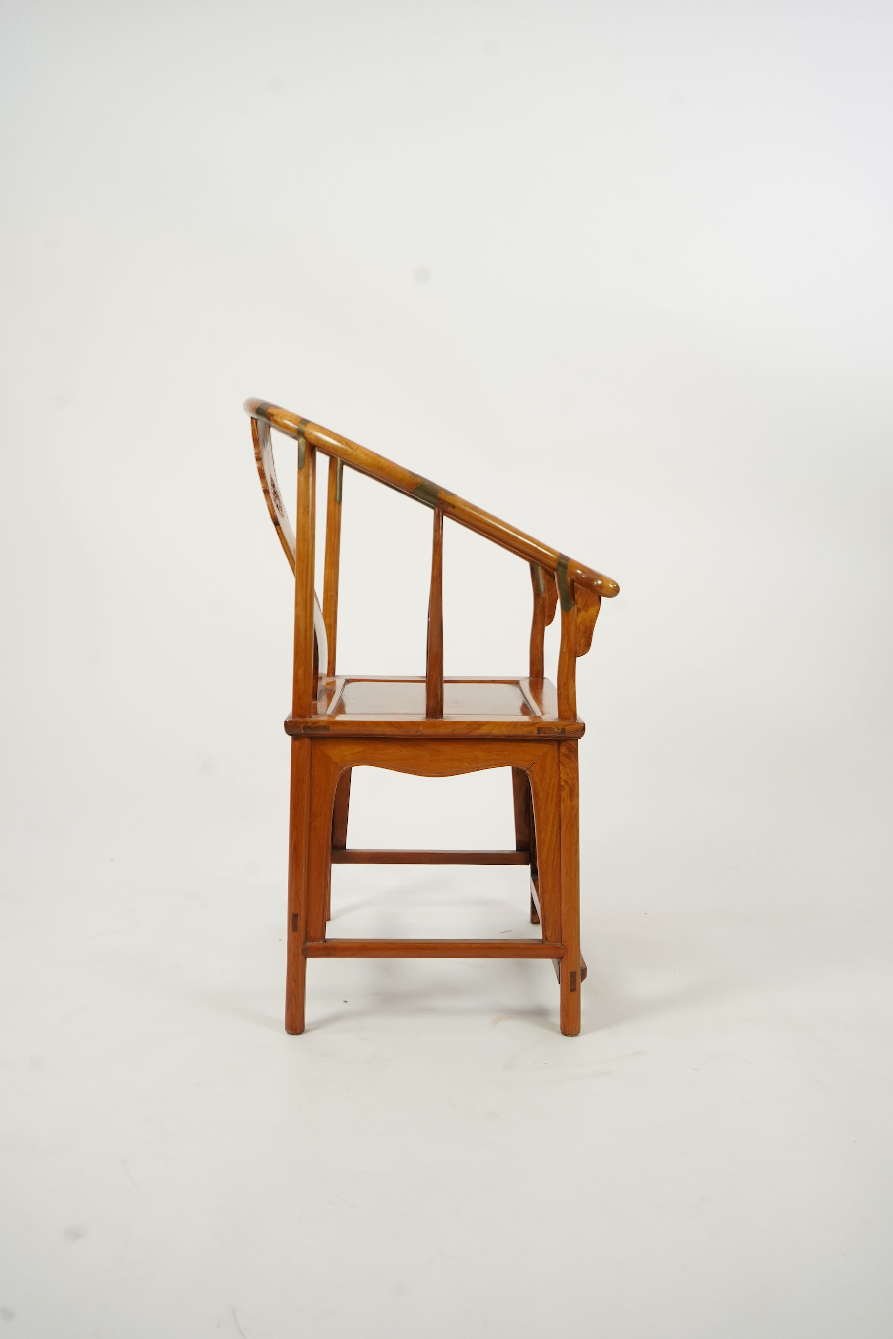 A Chinese huanghuali and brass mounted horseshoe-back armchair, quanyi, late 19th century